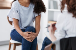 woman sitting and talking to her doctor about PHP and IOP